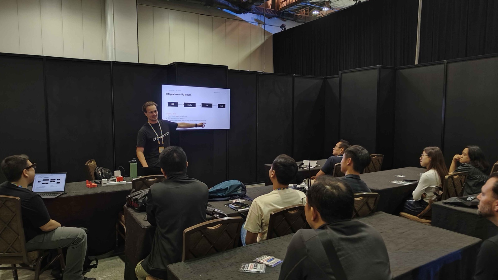 Presenting at the DEF CON Singapore workshop with participants seated and slides projected.